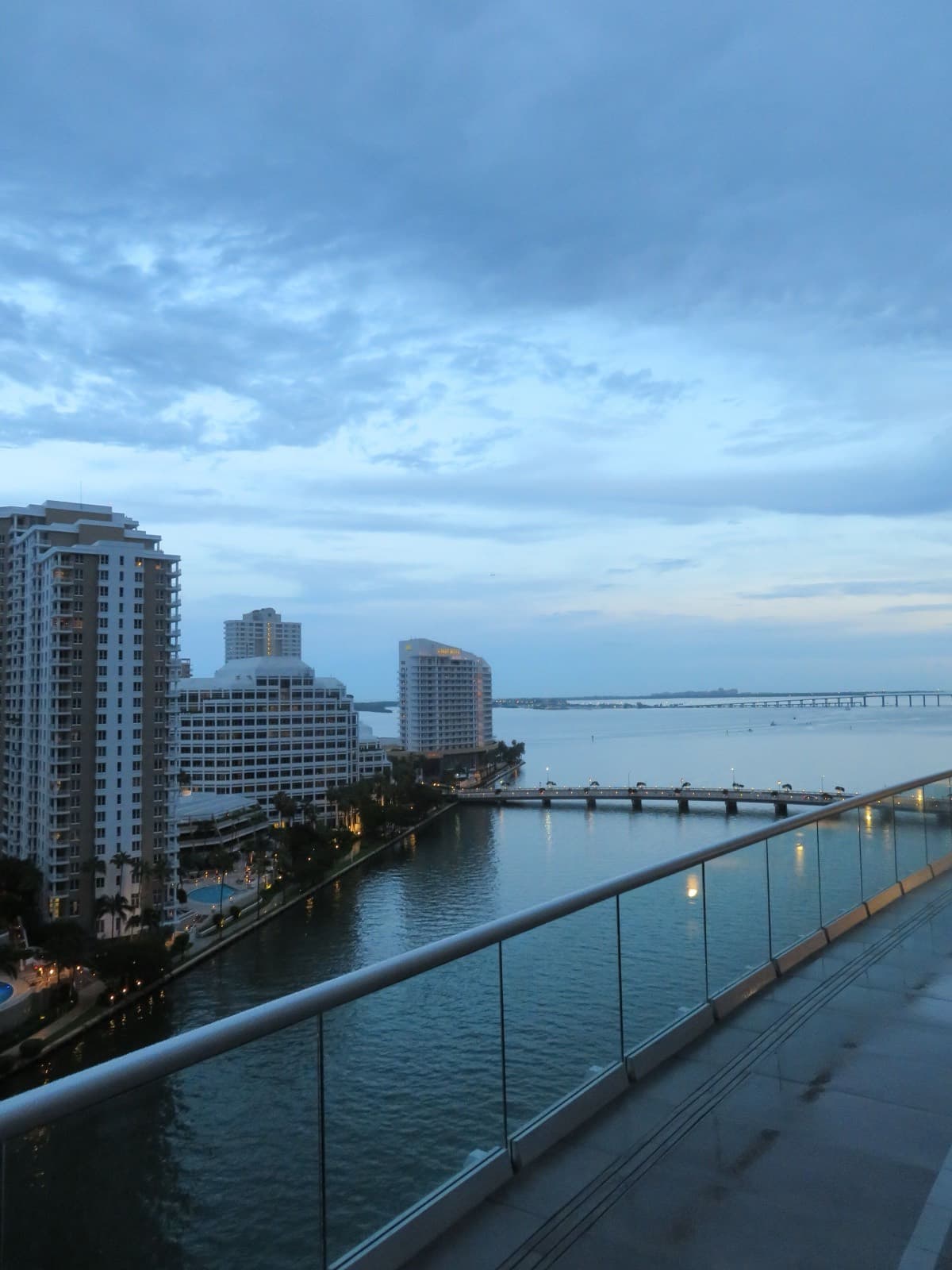 Brickell Key and the bay at dusk from a waterfront hotel balcony
