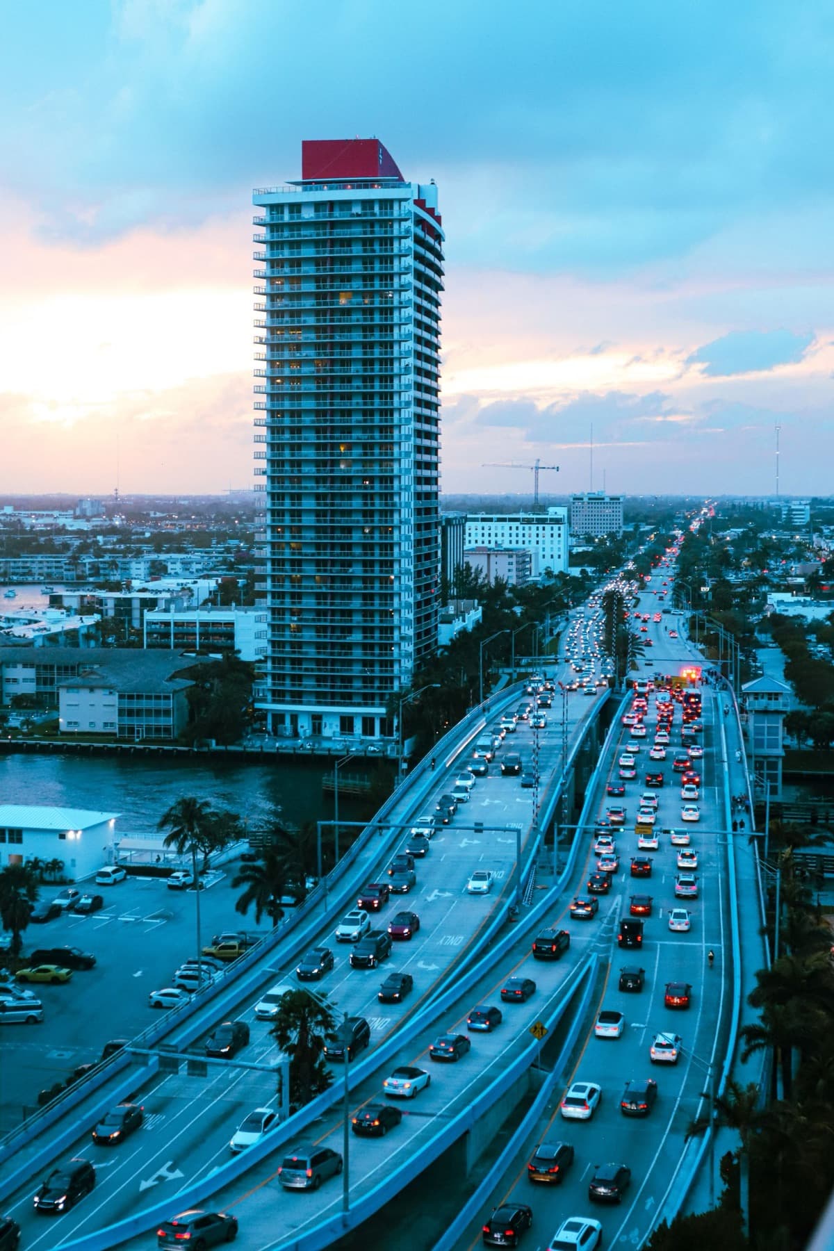 Miami waterfront highway in bumper-to-bumper rush-hour traffic at dusk
